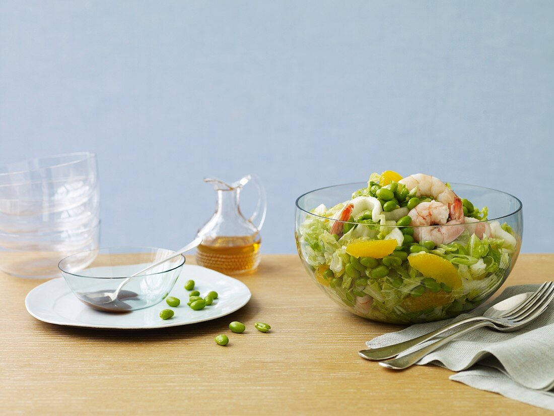 Shrimp and Pea Salad in a Serving Bowl; Dressing and Bowls