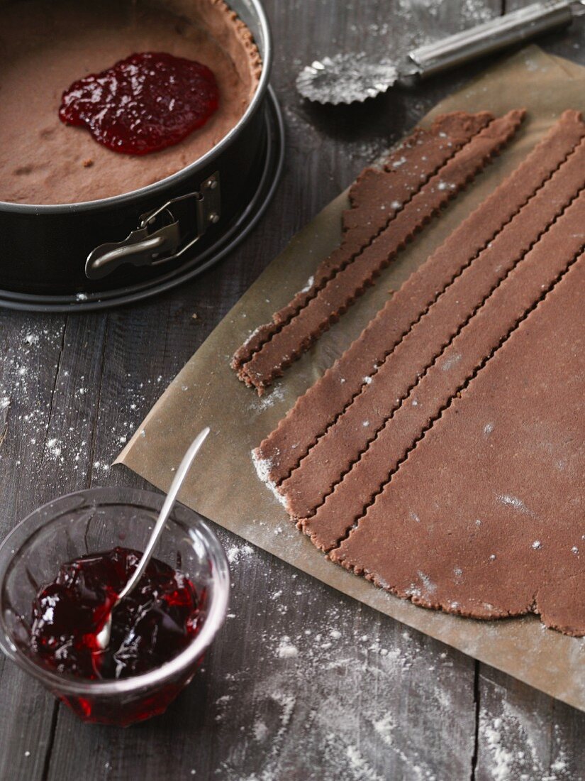 Strips of pastry being cut for a Linz tart