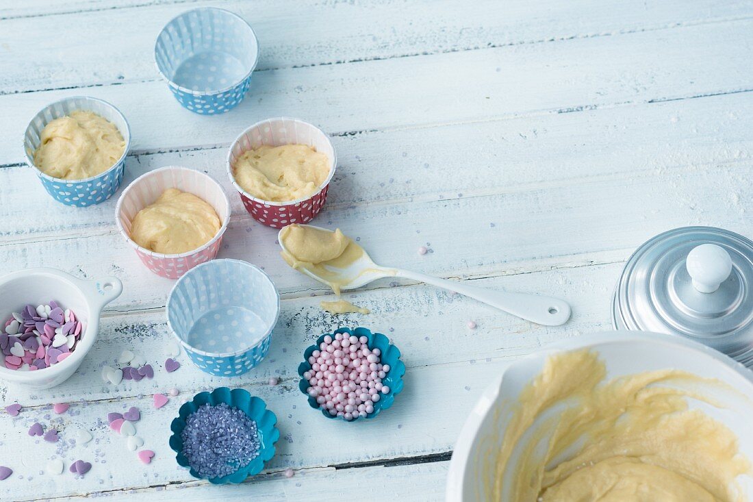 Muffin mix in paper cases and sugar decorations for children