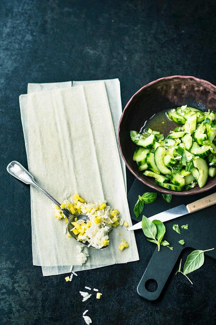 Strudel dough, rice, pineapple and cucumbers for making coconut rice paper rolls