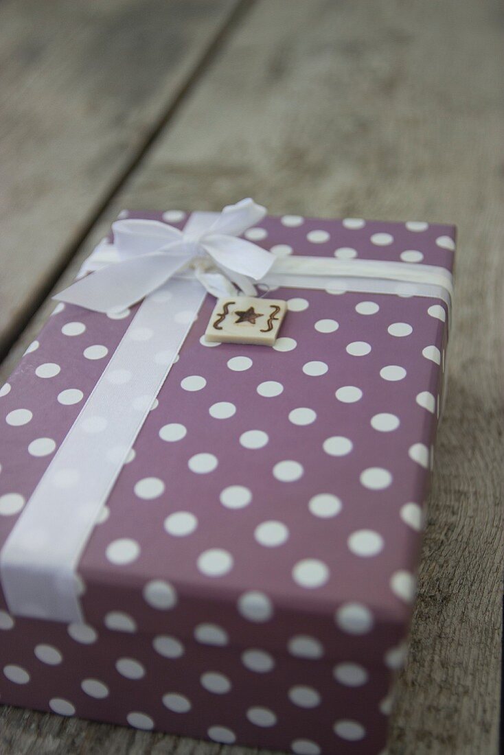 Wrapped gift with ribbon and hand-made gift tag