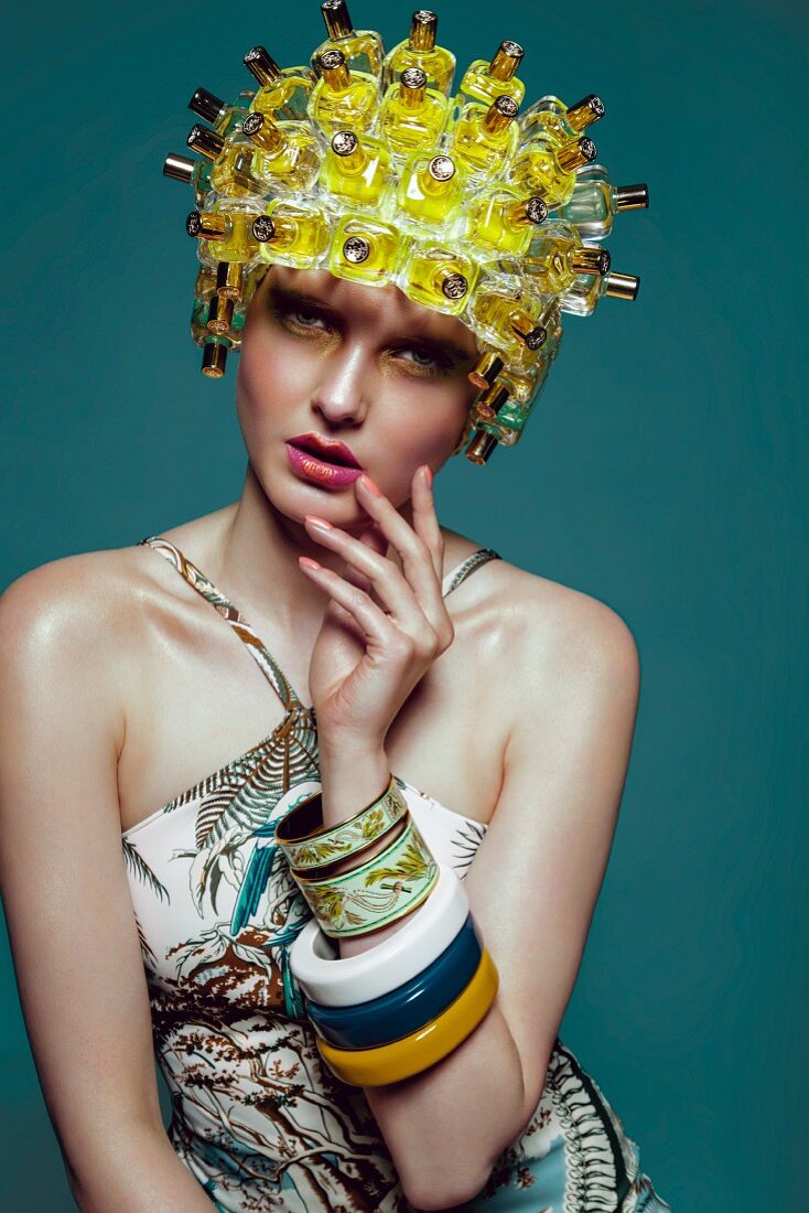 A woman wearing a wig made from perfume bottles