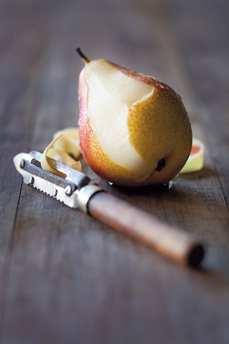 A partially peeled pear