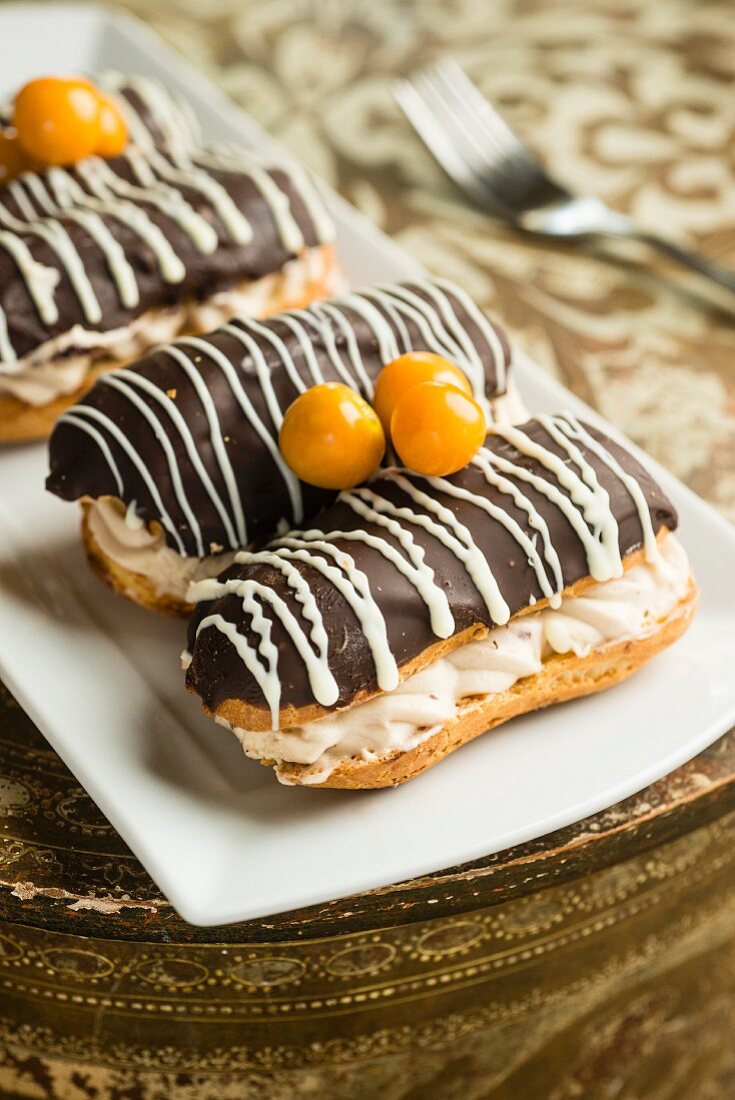 Chocolate eclairs decorated with physalis