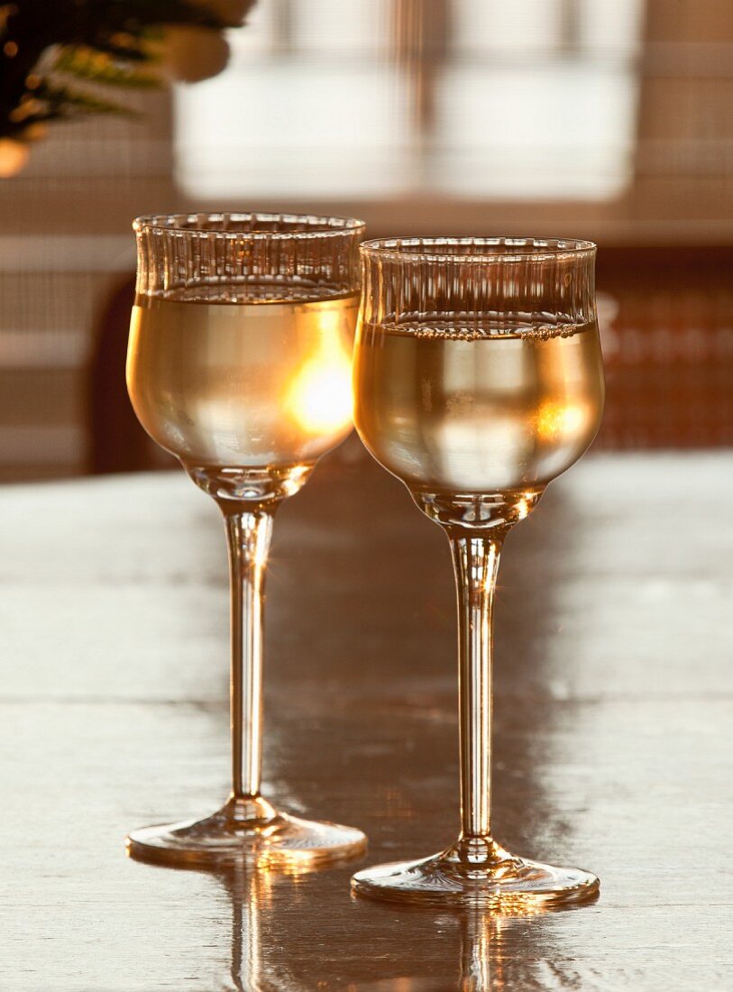Two elegant glasses of white wine on a table