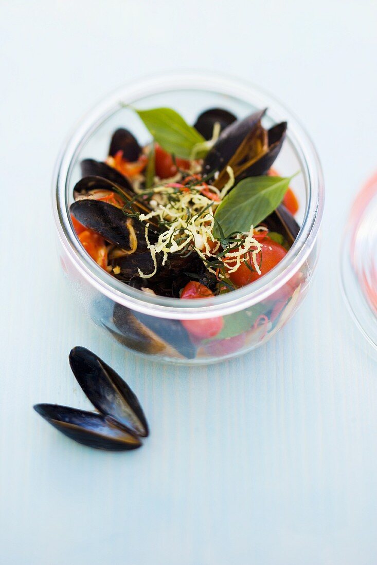 Mussels in a tomato and coconut broth with crispy ginger pesto in a jar