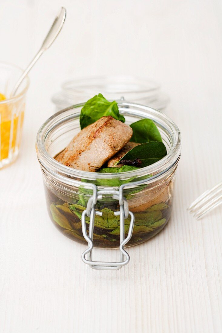 Veal fillet with spinach in a clove and lime leaf broth in a jar