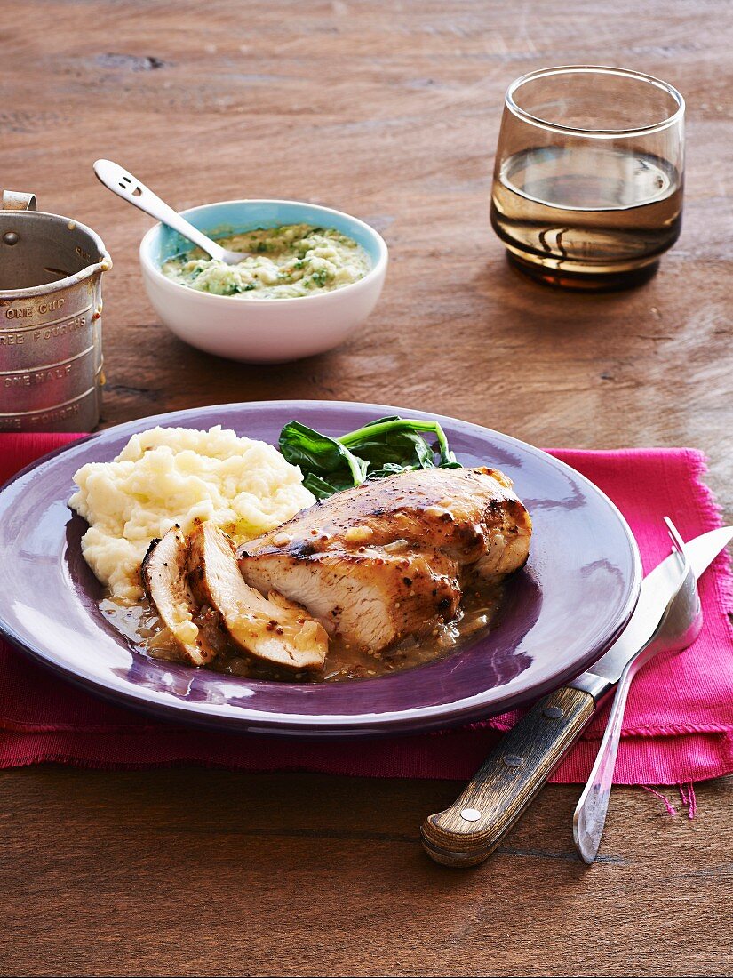 Chicken breast with a mustard glaze, mashed potatoes and leafy greens