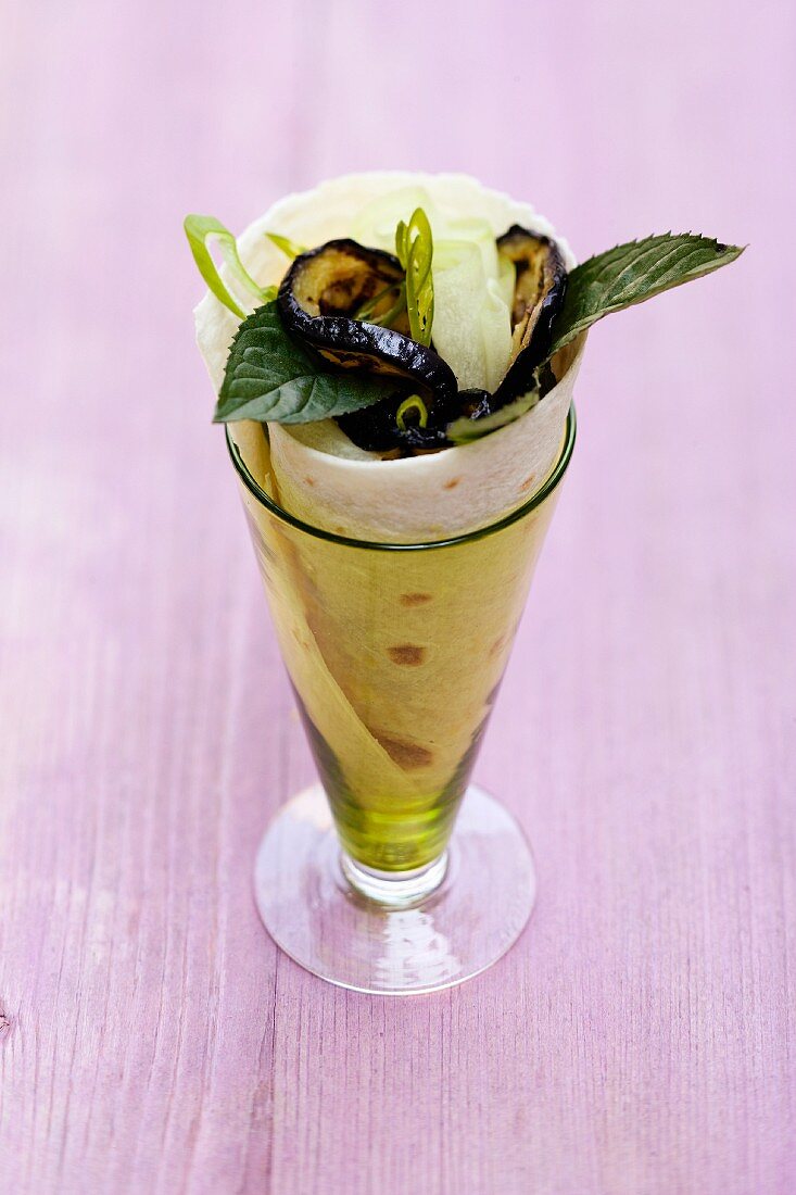 A courgette and mint wrap in a glass