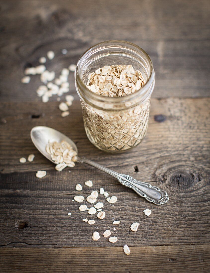 Oats in a screw top jar and on a silver spoon