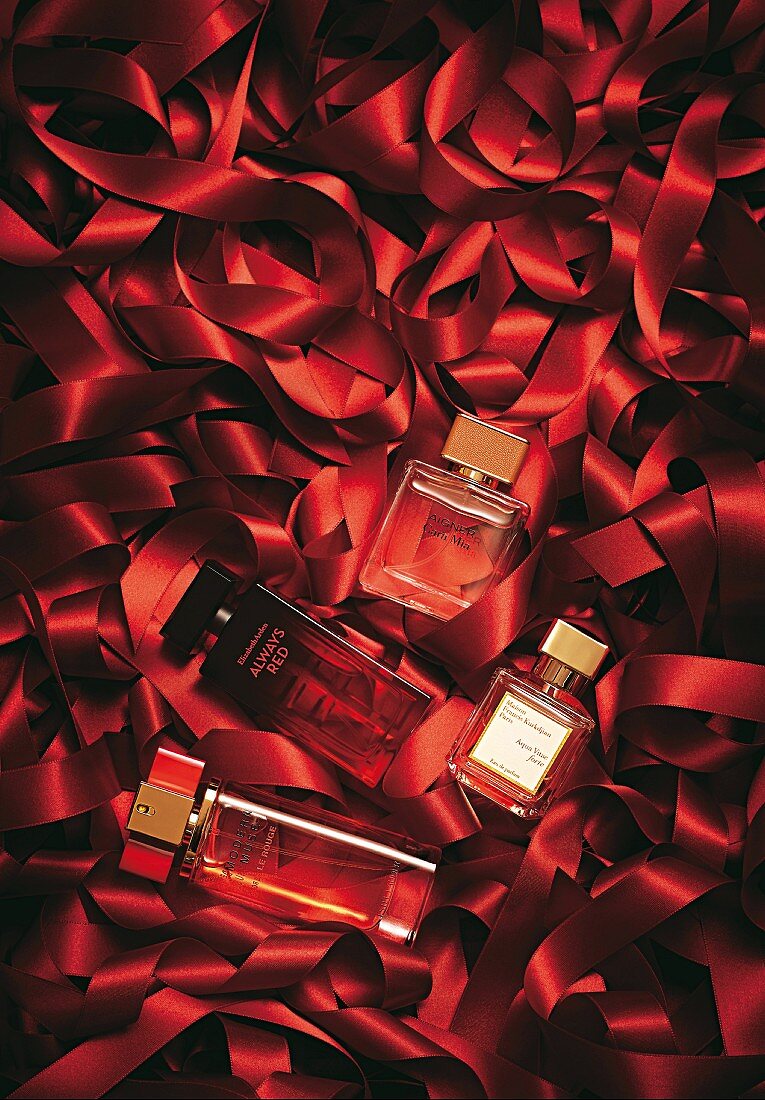 Perfume bottle on red satin ribbons