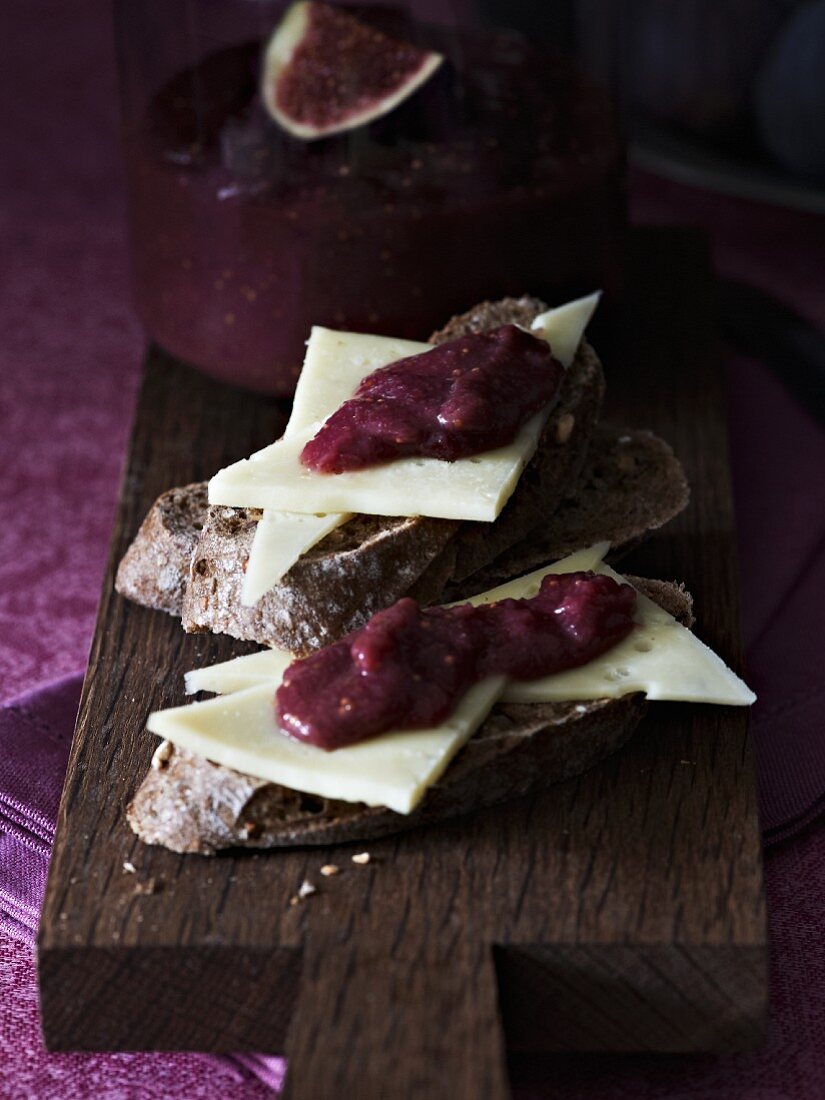 Slices of bread topped wit cheese and fig sauce