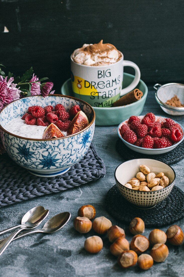Hot chocolate and muesli with raspberries, figs and nuts