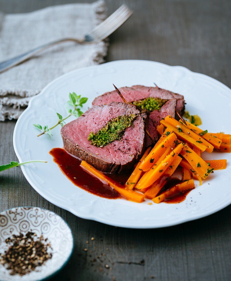 Beef fillet with a herb filling and glazed carrots
