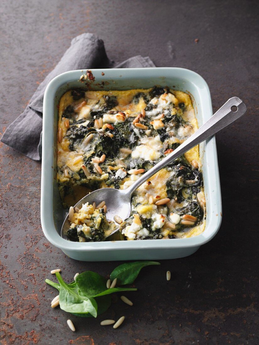 Spinach and polenta bake with sheep's cheese and pine nuts
