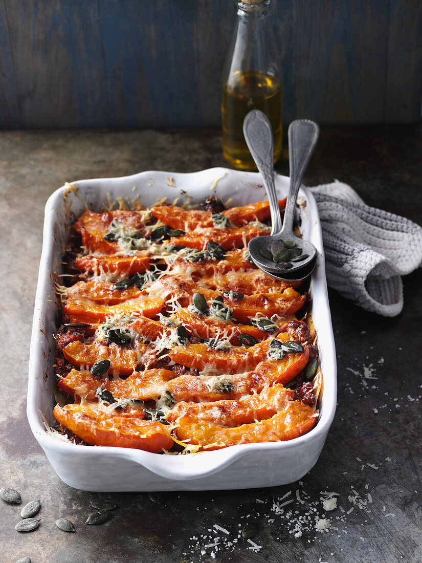Pumpkin and minced meat lasagne with Parmesan cheese and pumpkin seeds