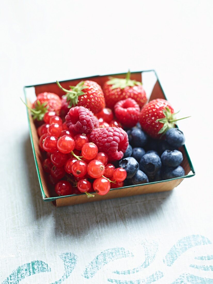Fresh berries in a wooden basket