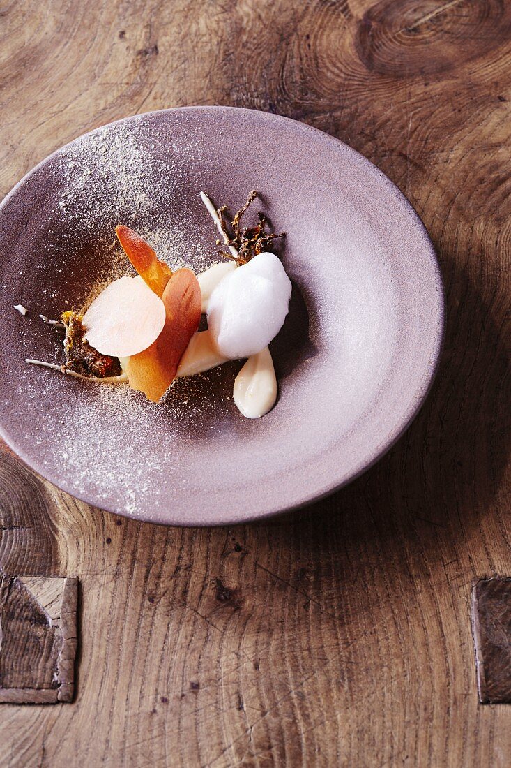 Coltsfoot ice cream with parsnips and vinegar foam at the restaurant Oaxen Krog run by chef Magnus Ek, Stockholm