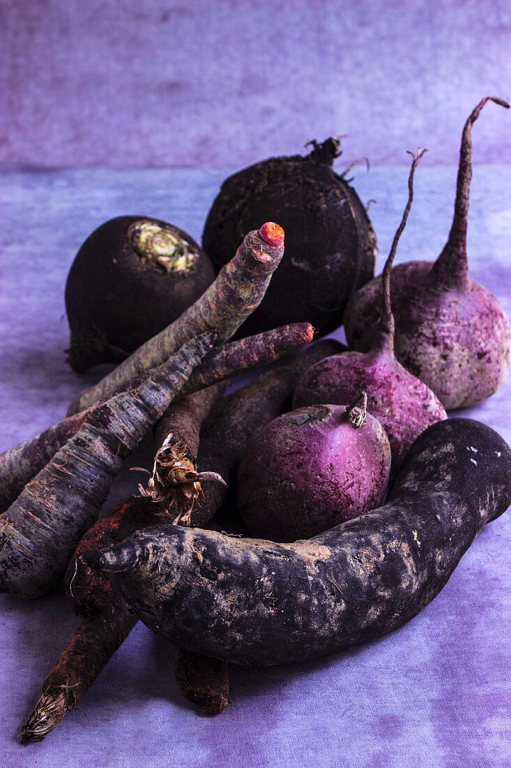 Dark root vegetables on a grey surface