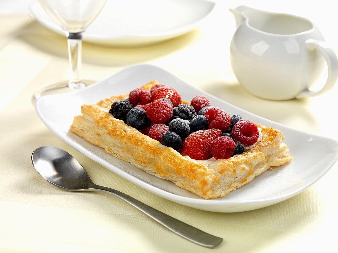 A summer fruits pasty served with cream