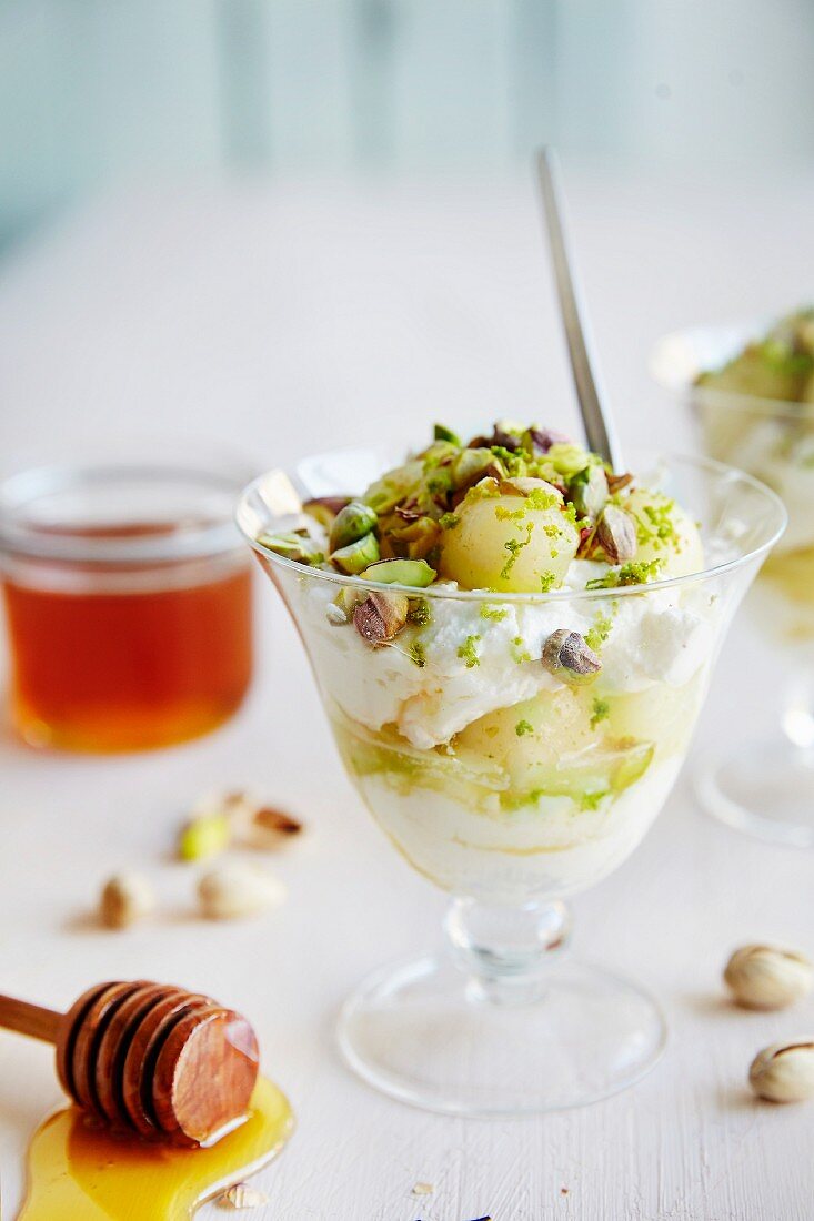 Greek yoghurt with honey, melons and pistachio nuts