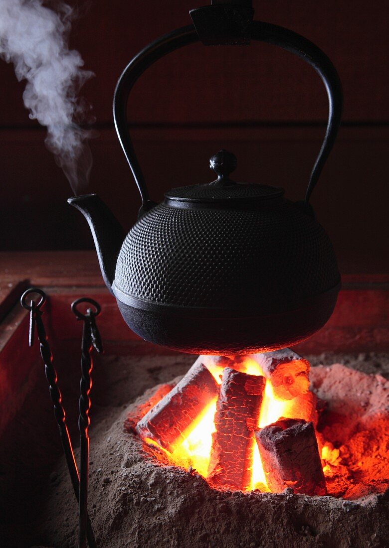 A kettle hanging over a fire