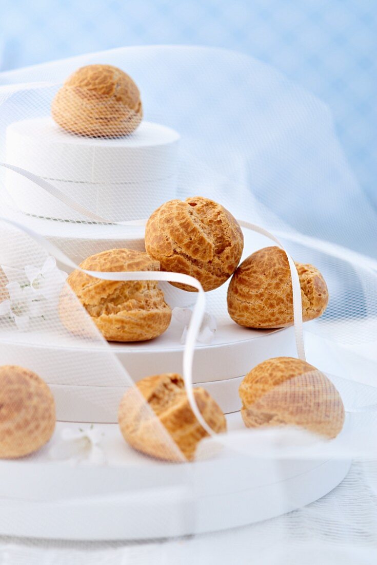 A multi-tiered wedding cake with profiteroles