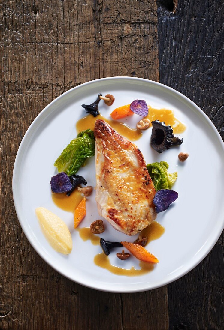 Roast pheasant breast with vegetables and wild mushrooms