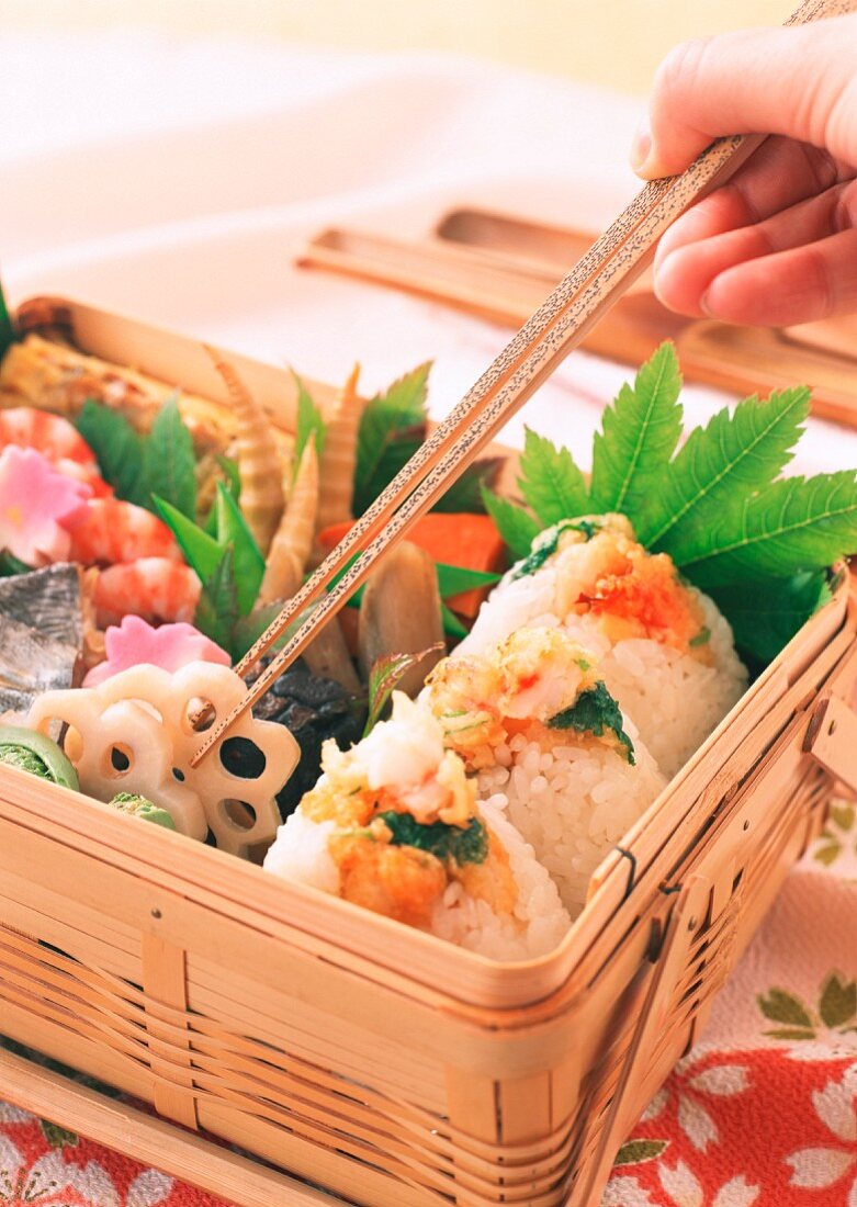 A selection of savoury Japanese food in a wooden basket