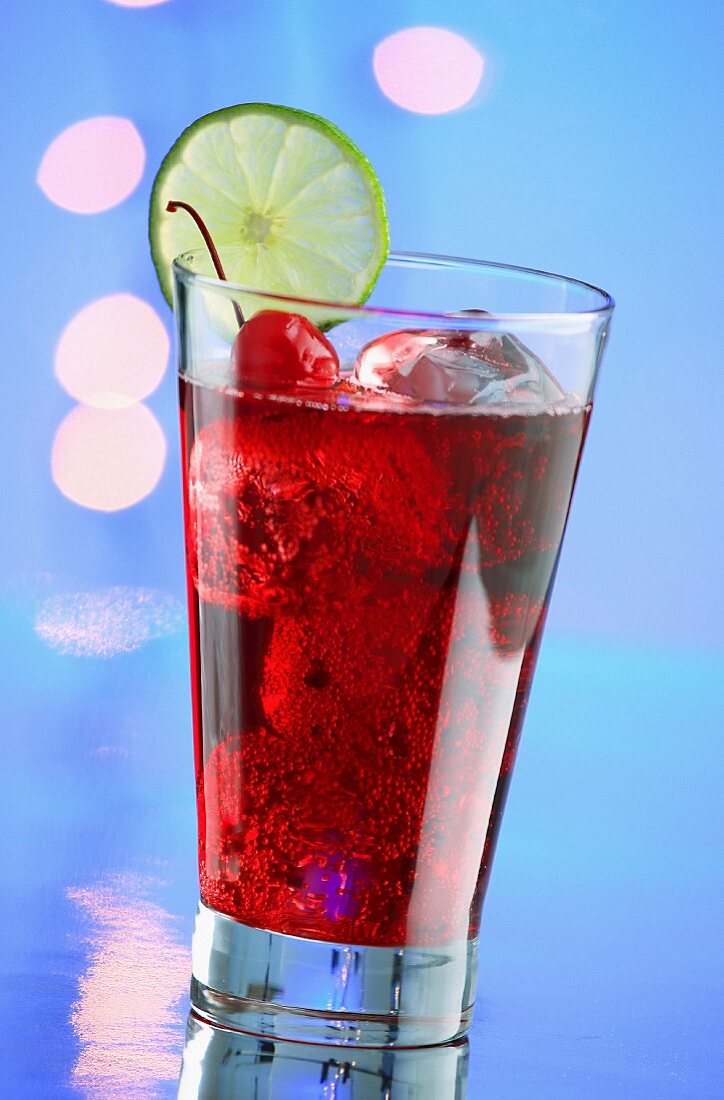 A red cocktail with ice cubes and cocktail cherries