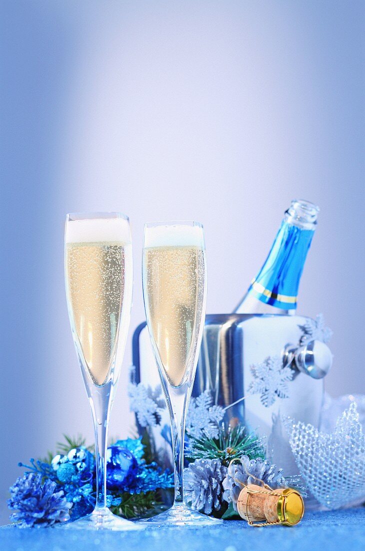A Christmas arrangement of champagne with glasses and a cooler
