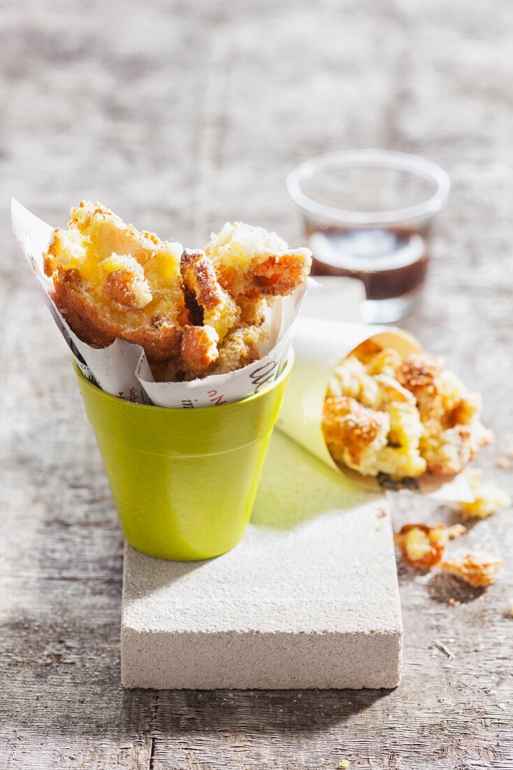 Kaiserschmarrn (shredded sugared pancake from Austria) with nuts in small paper cones