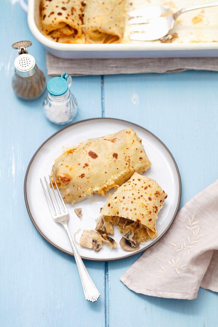 Oven-baked pancakes with sauerkraut and mushrooms