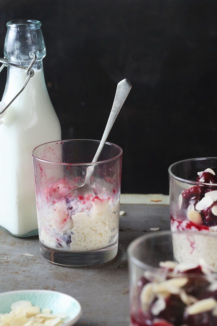 Half eaten rice pudding with cherries and flaked almonds