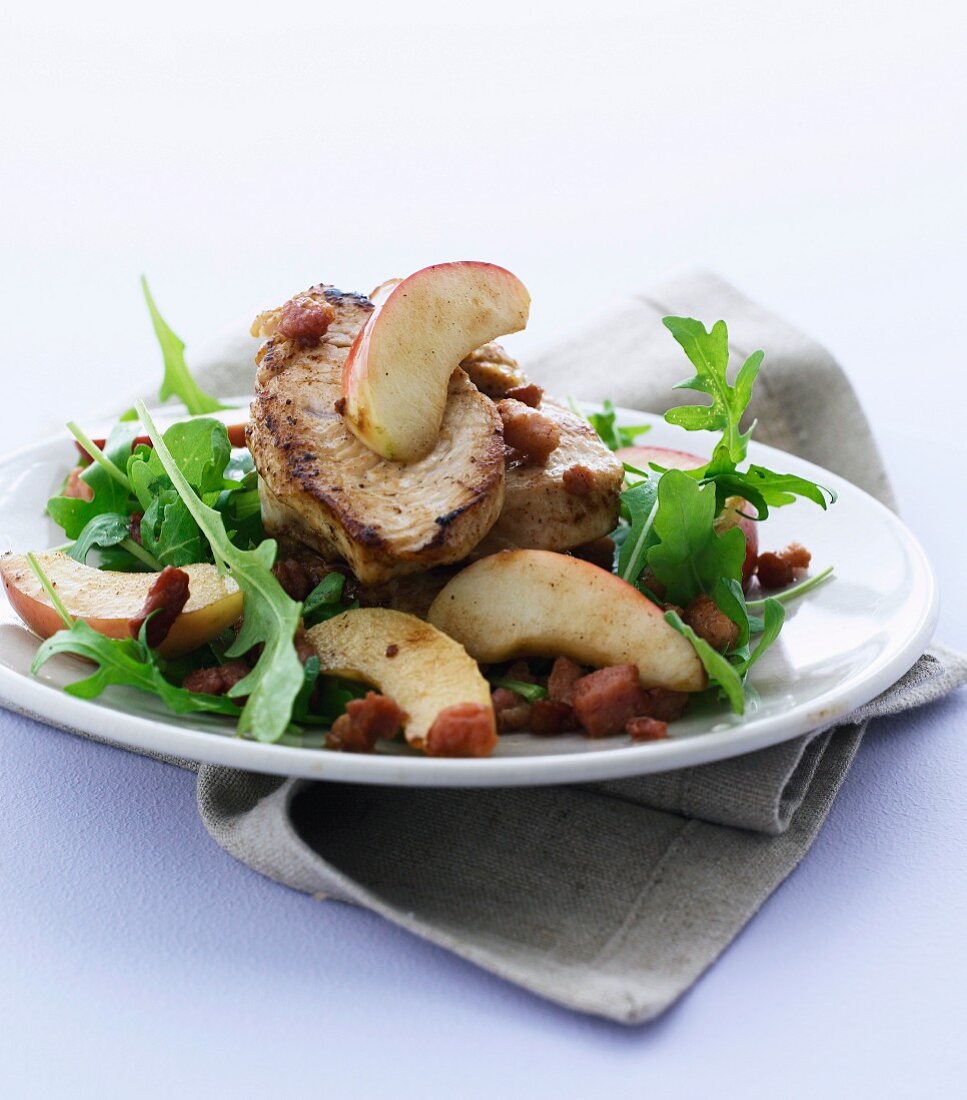 Pork fillet with steamed apples, bacon and rocket