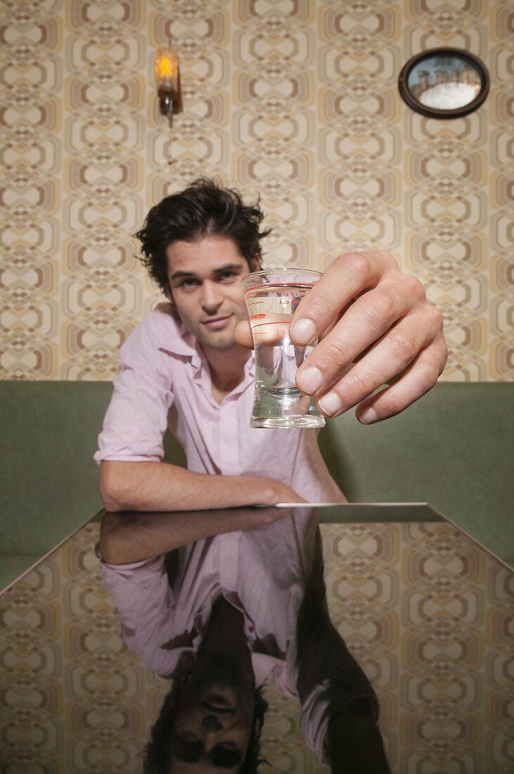 A man toasting with a shot glass