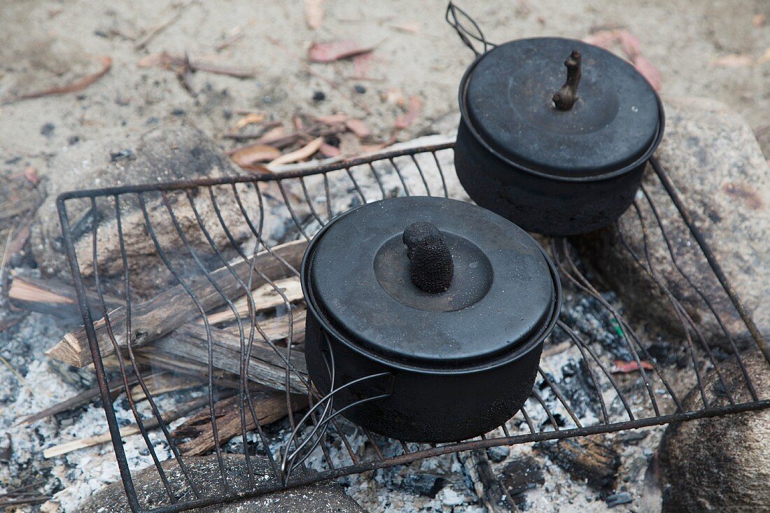 Cooking pot on an old wire rack over a campfire