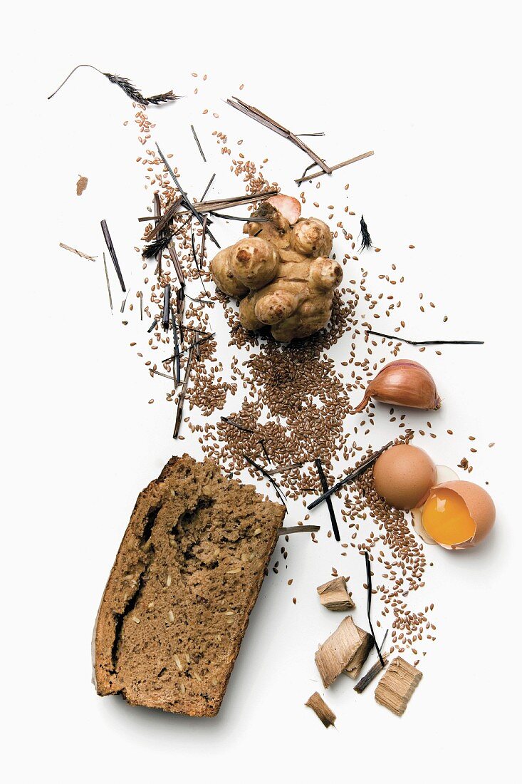 Bread and various other ingredients scattered over a white surface