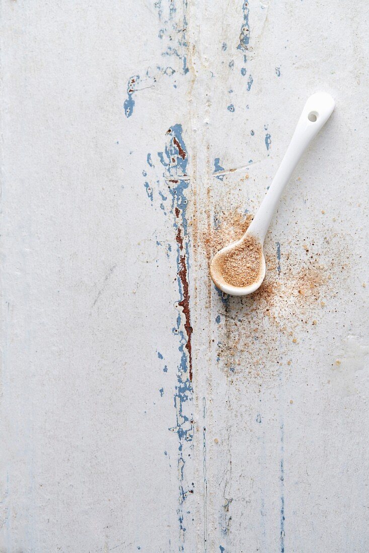 Cinnamon sugar on a white spoon