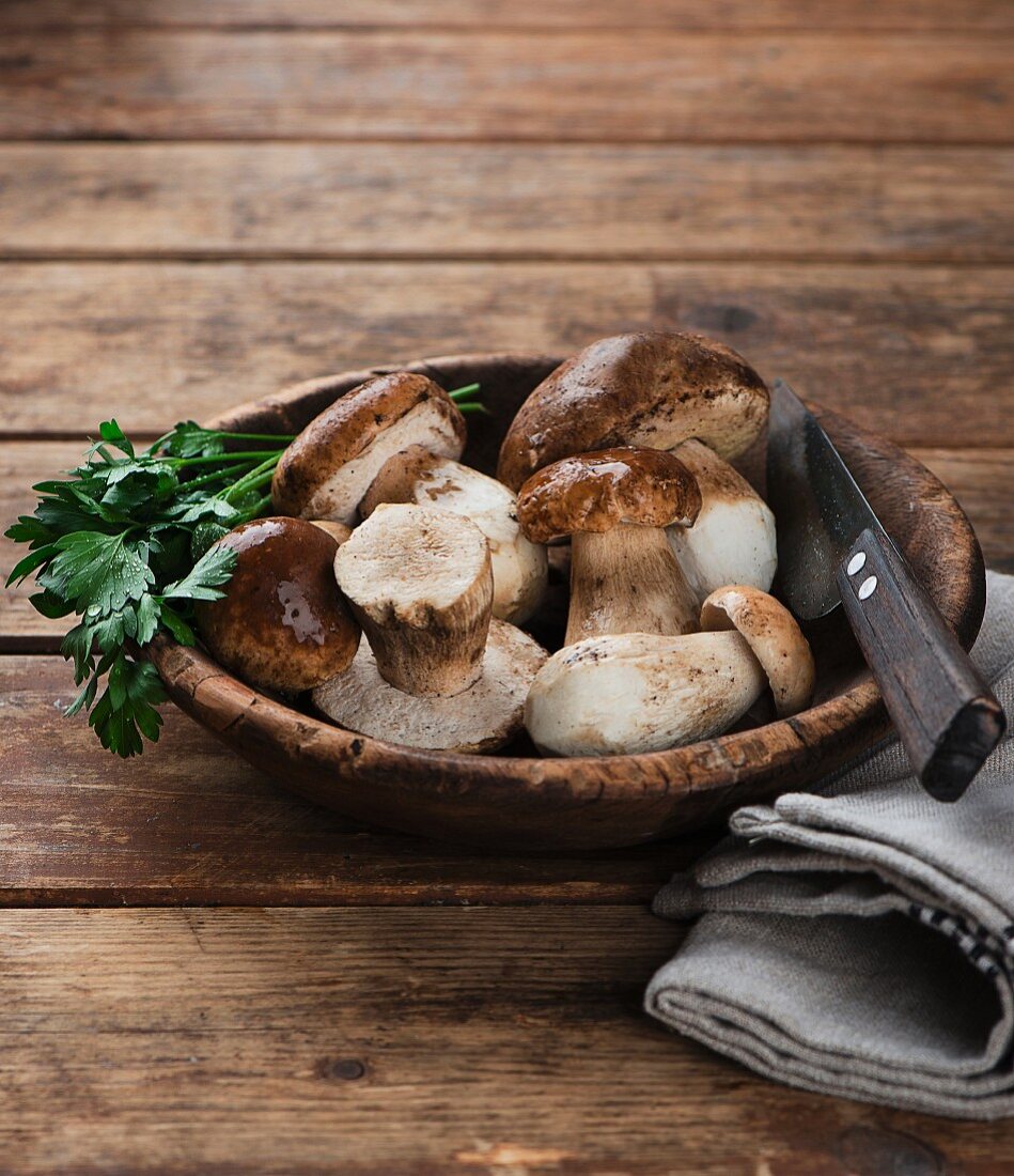 Fresh porcini mushrooms in a wooden dish