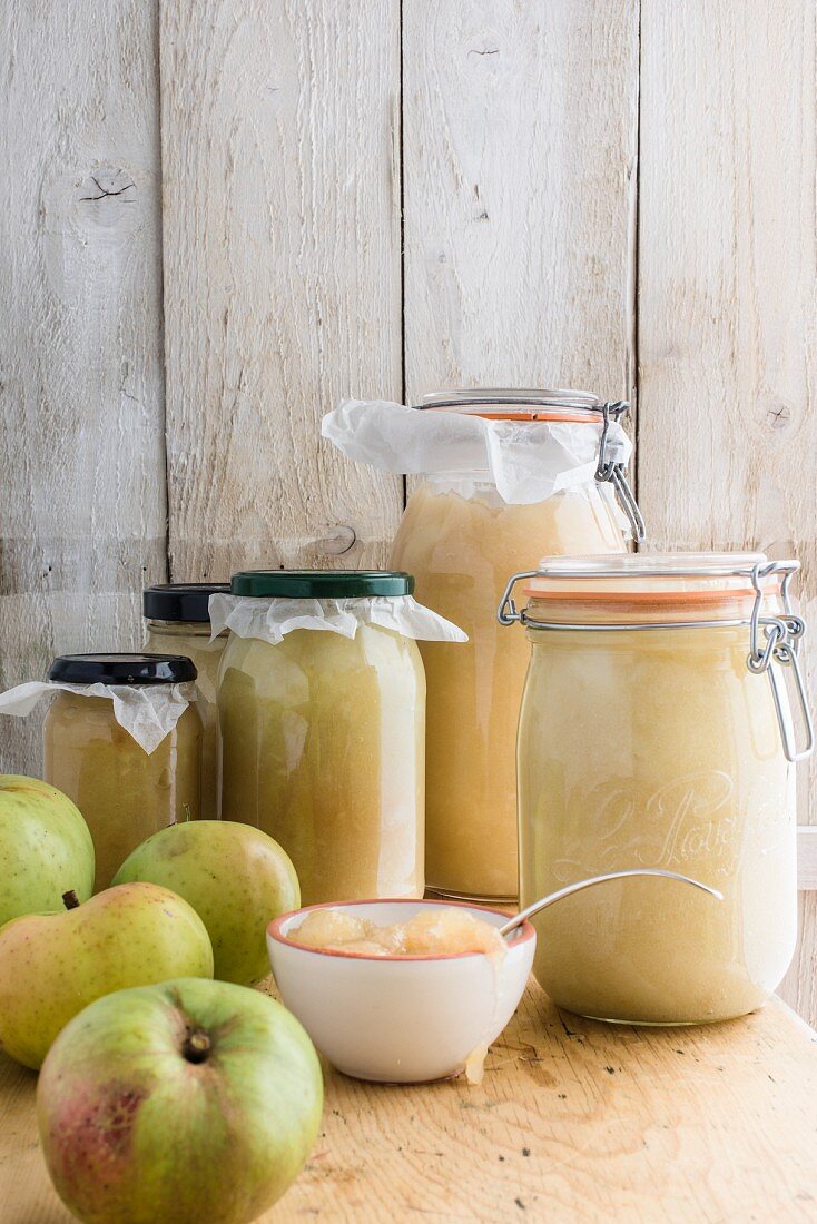 Jars of apple sauce and fresh apples