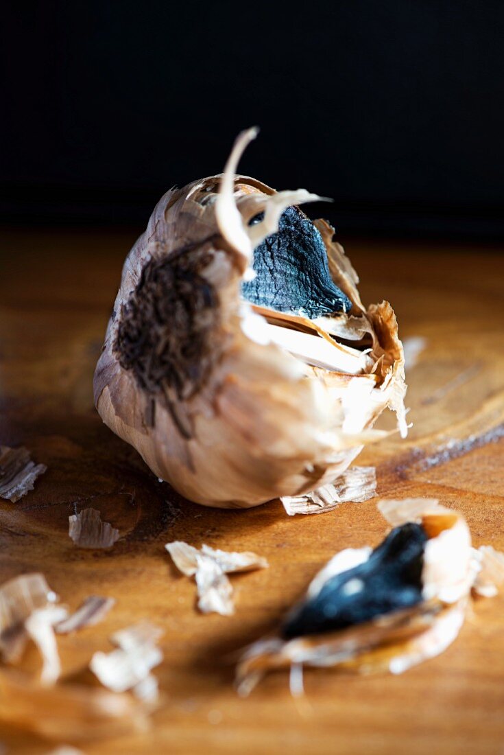 Black garlic on a wooden table