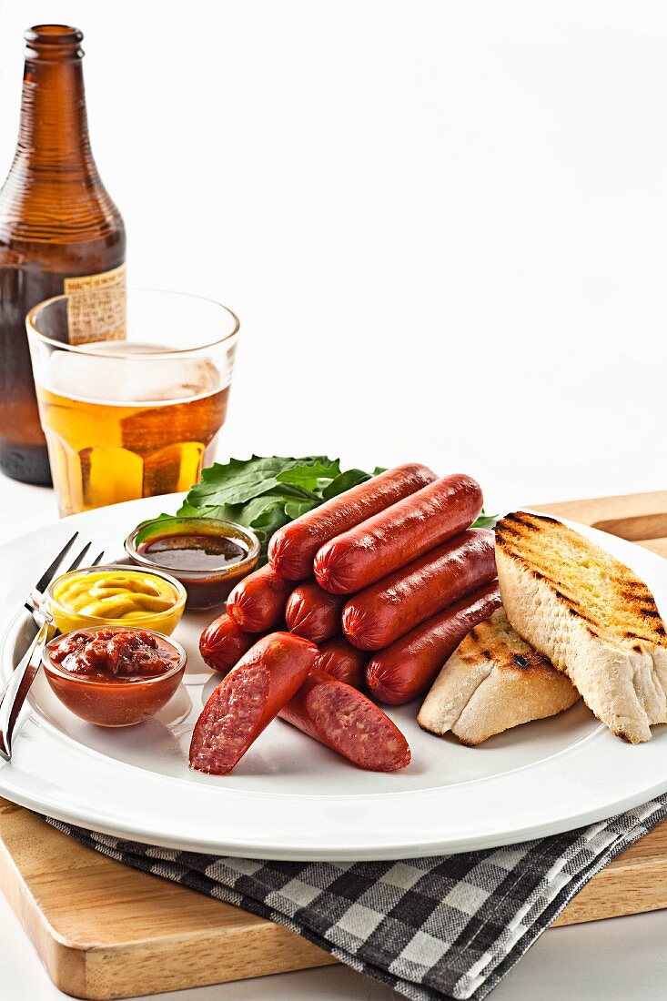 Sausages with grilled bread, sauces and beer