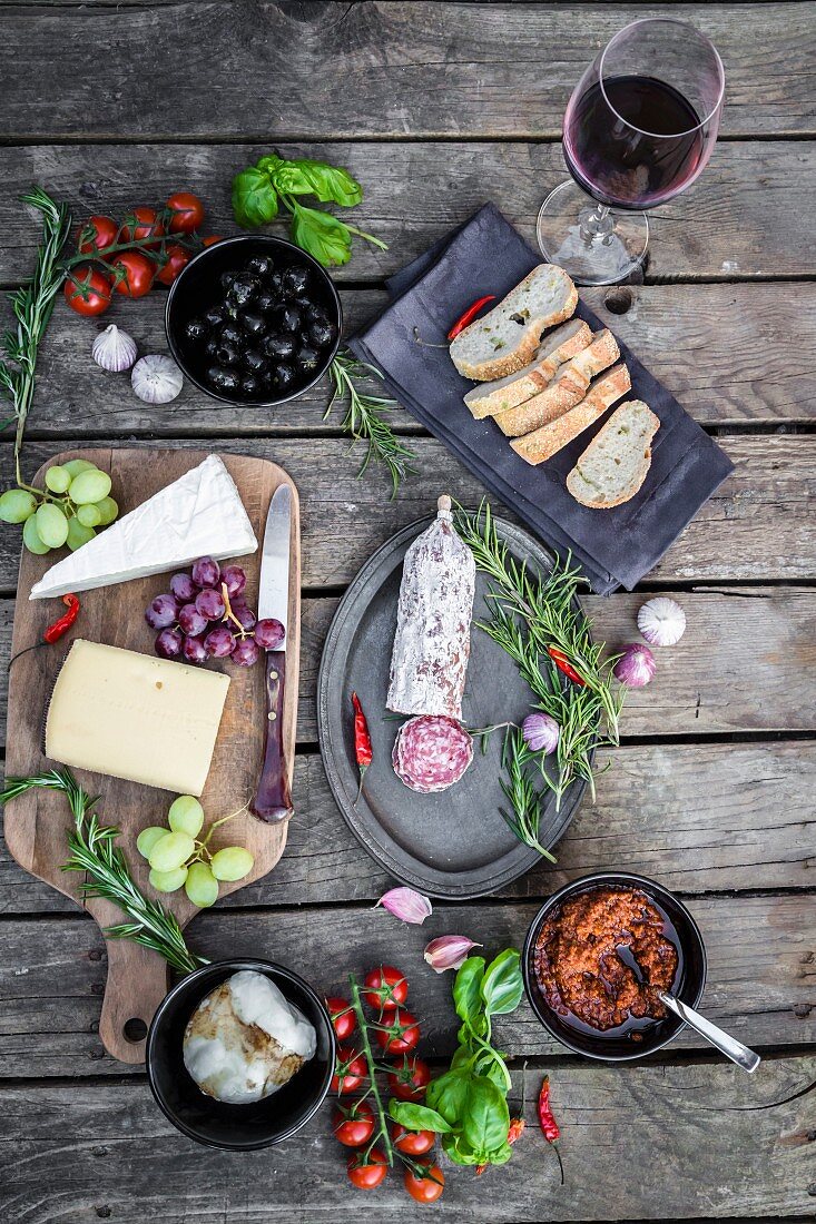Various Italian antipasti on a wooden table (seen from above)