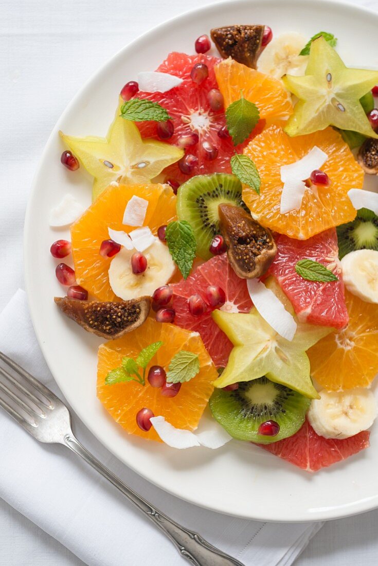 Exotic fruit salad with grated coconut and mint