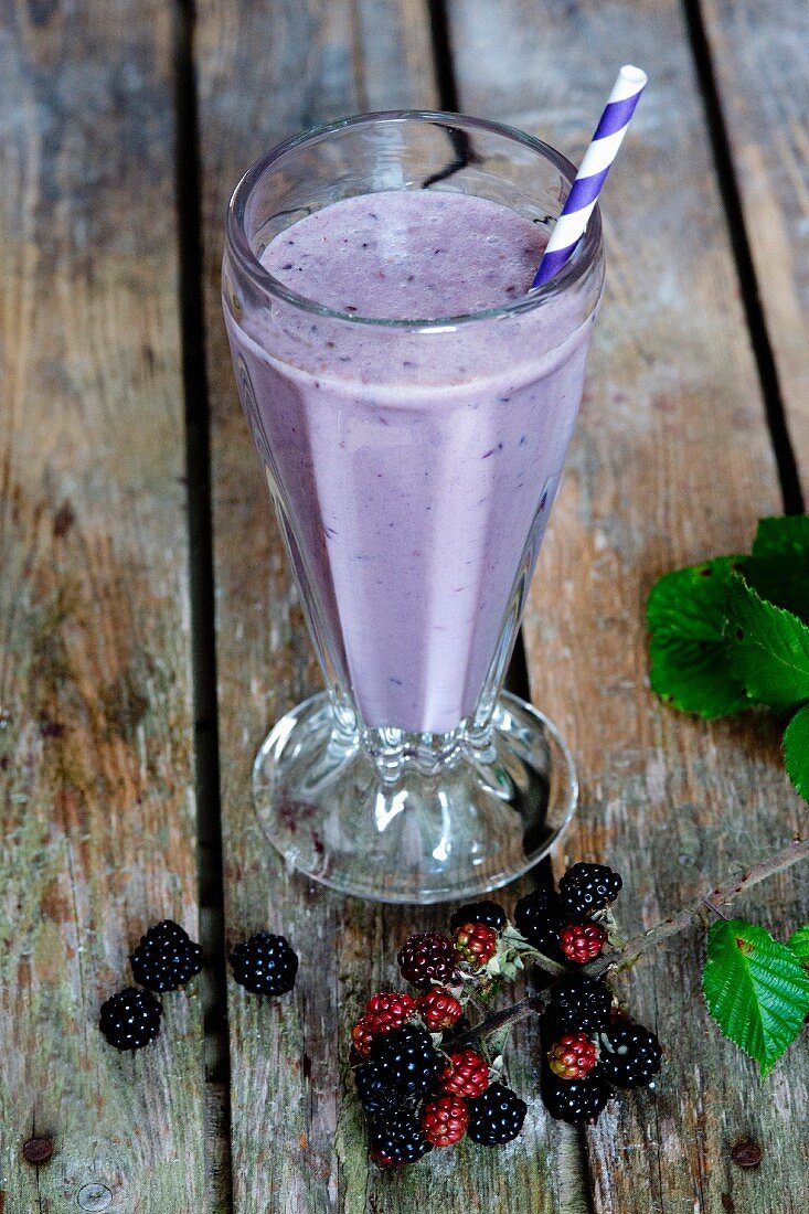 A blackberry smoothie on a wooden surface