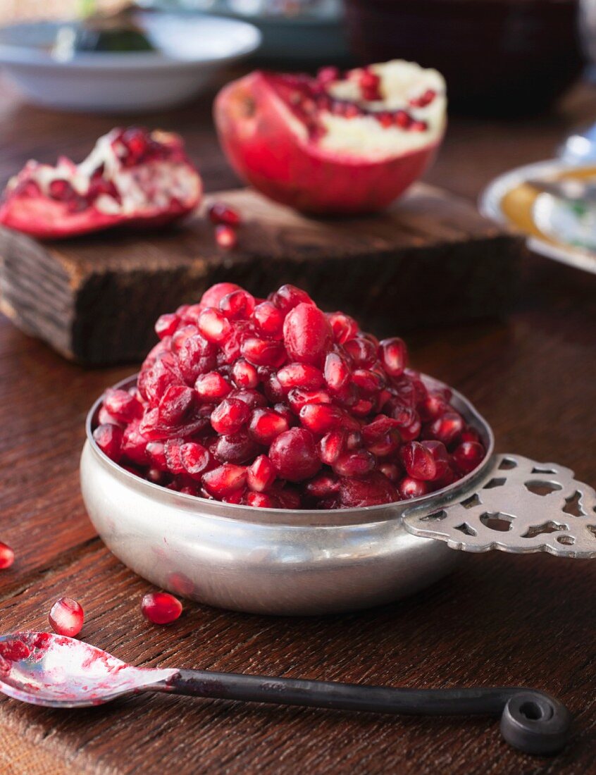 Cranberry and pomegranate relish in a silver bowl on a wooden table