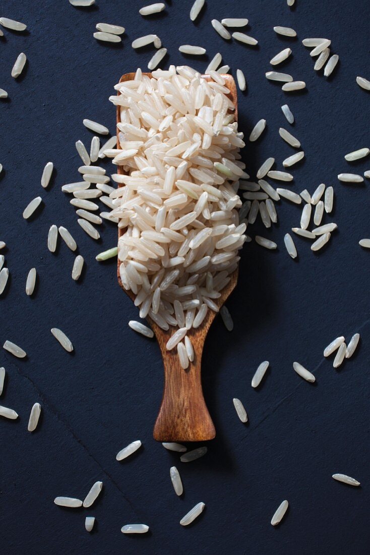 Long grain rice on a wooden scoop