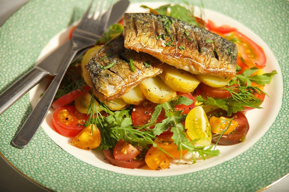 Mackerel fillets on a potato and tomato salad