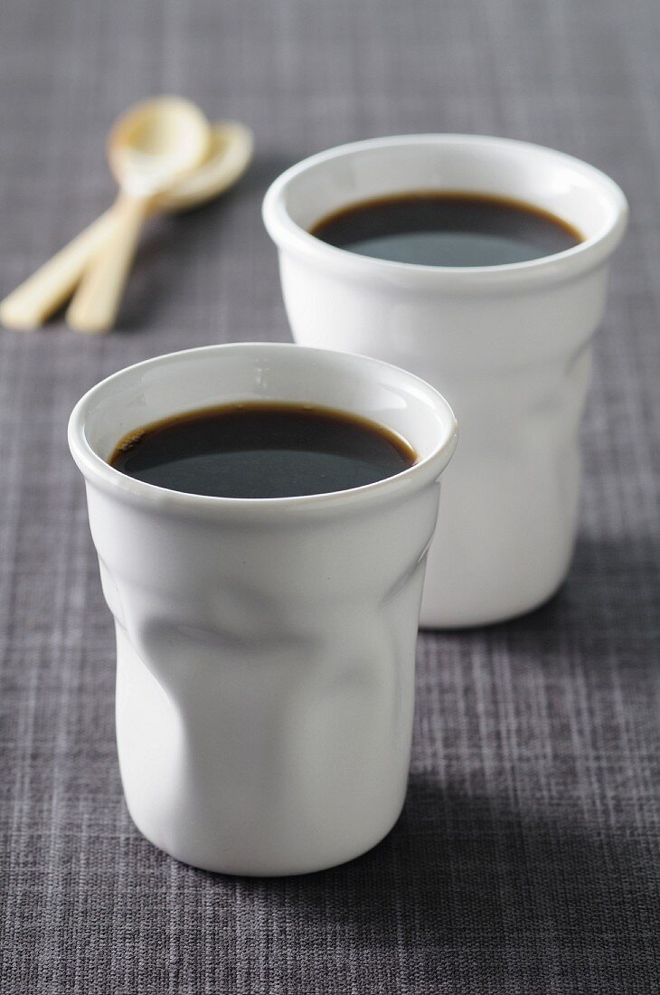 Black coffee into ceramic cups